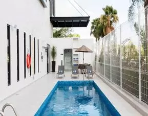 Relaxing outdoor pool at the Hampton Inn by Hilton Cancun Cumbres.
