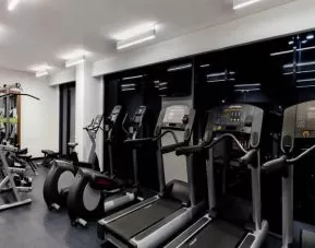Fitness center with treadmills and machines at the Hampton Inn by Hilton Cancun Cumbres.