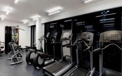 Fitness center with treadmills and machines at the Hampton Inn by Hilton Cancun Cumbres.