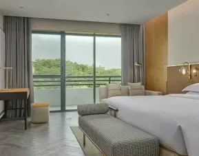 king suite with lounge, desk, and chair at Hilton Guangzhou Science City.