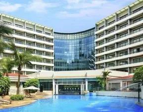 stunning outdoor pool with sunbeds at Hilton Guangzhou Science City.