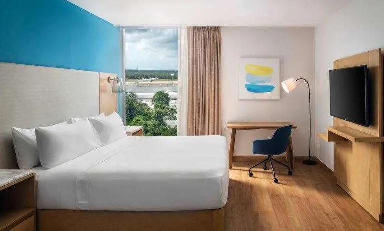 King bedroom with desk and TV screen at the Hilton Garden Inn Cancun Airport.