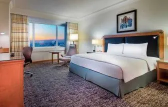 spacious delux king room with desk, chair, and TV at Adana HiltonSA.
