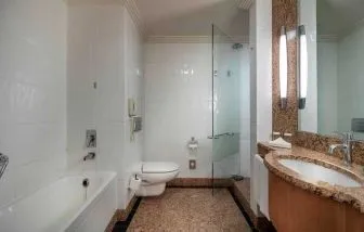 spacious bathroom with bath and shower at Adana HiltonSA.
