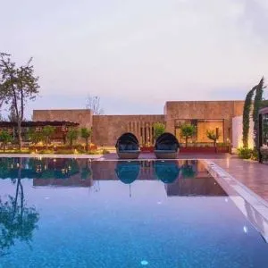 stunning outdoor pool with sun beds and seating area at Adana HiltonSA.