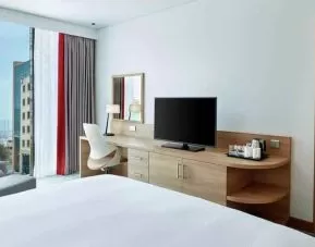 King suite with working station along the window at the Hilton Garden Inn Muscat Al Khuwair.