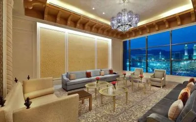 Seating area with large window and view at the Hilton Makkah Convention Hotel.