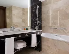 clean and spacious king bathroom with bath and shower at Hilton Astana.