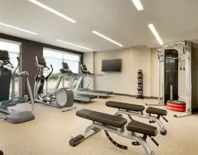 Fitness center with machines at Embassy Suites by Hilton Oahu Kapolei.