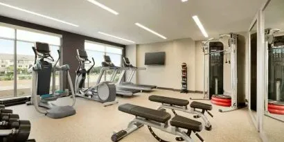 Fitness center with machines at Embassy Suites by Hilton Oahu Kapolei.