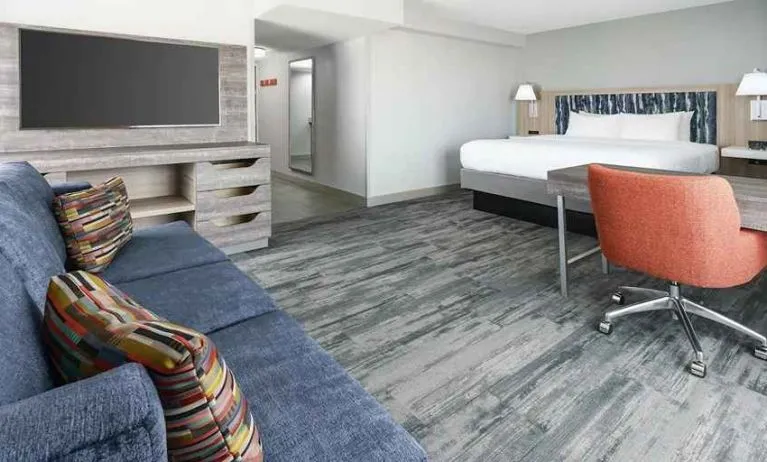 luxurious king suite with lounge and work area at Hampton Inn & Suites Tampa-Ybor City/Downtown.