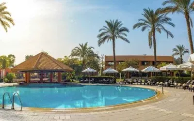 stunning outdoor pool with sunbeds and umbrellas at Hilton Cairo Heliopolis.