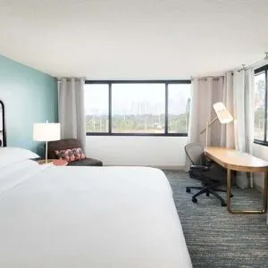 Hotel bedroom with working station and TV screen at the Sheraton Miami Airport Hotel.