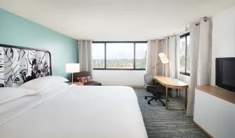 Hotel bedroom with working station and TV screen at the Sheraton Miami Airport Hotel.