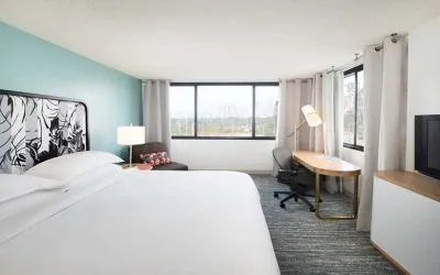 Hotel bedroom with working station and TV screen at the Sheraton Miami Airport Hotel.