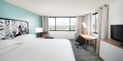 Hotel bedroom with working station and TV screen at the Sheraton Miami Airport Hotel.