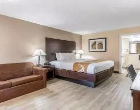 Spacious king suite with couch and TV at Quality Inn Pasadena.