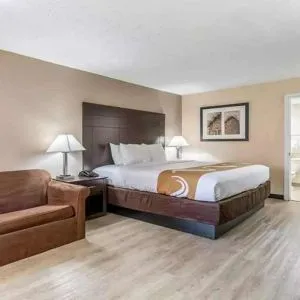 Spacious king suite with couch and TV at Quality Inn Pasadena.