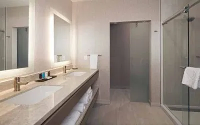 Guest bathroom with shower at H Hotel Los Angeles, Curio Collection By Hilton.
