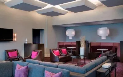 Comfortable couches in open-plan setting ideal for coworking at Courtyard By Marriott New York JFK Airport.