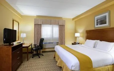 Double bed guest room in Holiday Inn Express Philadelphia Airport, with window and TV set.
