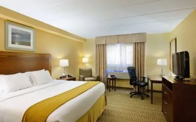 Guest room in Holiday Inn Express Philadelphia Airport, with double bed and chair/desk for working.