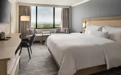 Guest room in the Westin Atlanta Airport Hotel, with large bed and workspace desk and chair.