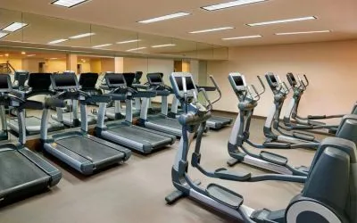 The hotel fitness center is equipped with numerous exercise machines for guests.