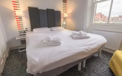 Zoomed in view of the king size bed in the guest suite room at the Victoria Inn, London, UK.