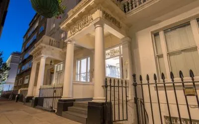 The nocturnal exterior of the Victoria Inn, including stylish white columns.