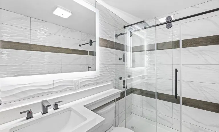 Guest bathroom with shower at Hotel Opus Bronx.
