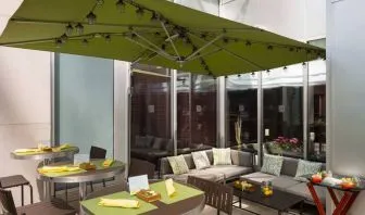 The hotel’s outdoor patio seating area, with mix of tables and chairs, and sofa seating.