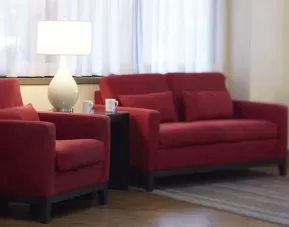 The hotel lobby lounge has comfortable seating and is brightly lit.