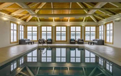 The hotel’s indoor pool has armchairs and sofas nearby.