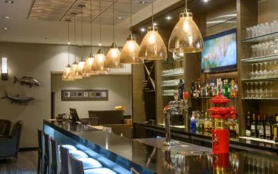 The hotel’s bar has tall stools, art on the wall, and a broad selection of beverages.