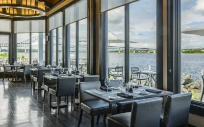 Rodd Miramichi River’s on-site restaurant has hard floors and tables with waterfront views.