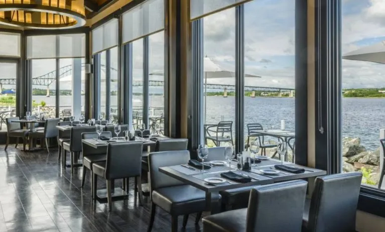 Rodd Miramichi River’s on-site restaurant has hard floors and tables with waterfront views.
