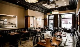 The hotel’s adjoining restaurant offers tables for two or four diners in a stylish, well-lit setting.