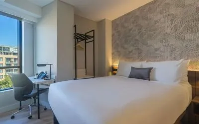 King bedroom with work space and natural light at Hotel Kith.