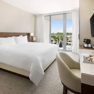 Spacious king bedroom with work desk at The Altair Hotel Bay Harbor.