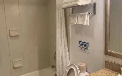 Guest bathroom with shower and tub at Sky Hotel Flushing - Laguardia Airport.