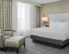 King bed with natural light at DoubleTree Atlanta Airport.