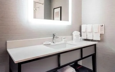 Guest bathroom with shower at Courtyard By Marriott Boston Brookline.
