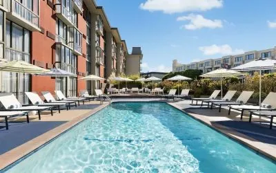 Stunning outdoor pool with sun beds and umbrellas at Hotel Caza.
