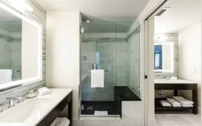 Private guest bathroom with shower at The Mosaic Hotel Beverly Hills.