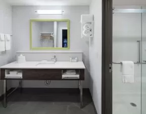 Private guest bathroom with shower at Hampton Inn & Suites Cape Canaveral Cruise Port.
