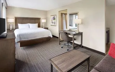 Day use room with work desk and sofa at Hampton Inn & Suites Alexandria.