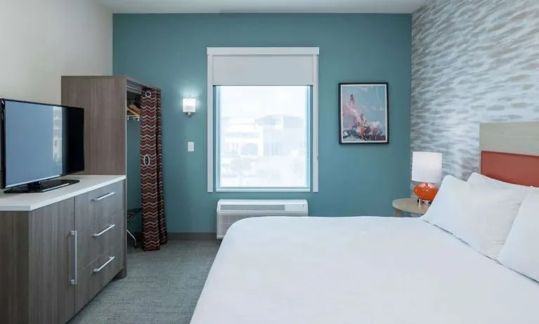 King bed with TV at Home2 Suites By Hilton Cape Canaveral Cruise Port.