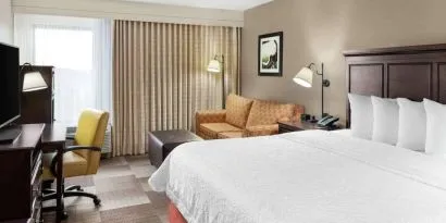 Day use room with work desk and sofa at Hampton Inn Dallas-Irving-Las Colinas.