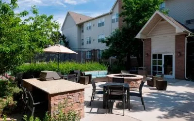 Fire pit and BBQ grill area at Residence Inn By Marriott Denver Highlands Ranch.